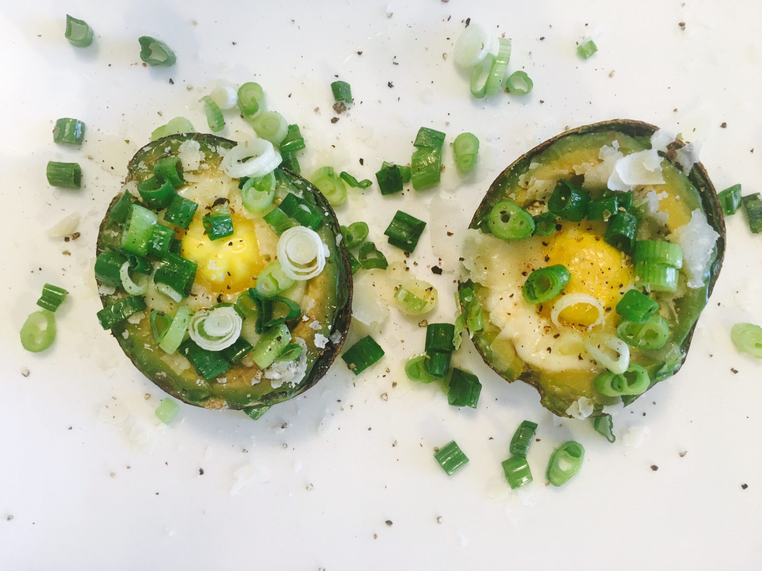 Avocados baked with eggs and scallions for breakfast